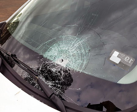 customer's car with broken windshield at their home by RS Auto Glass of Hamilton